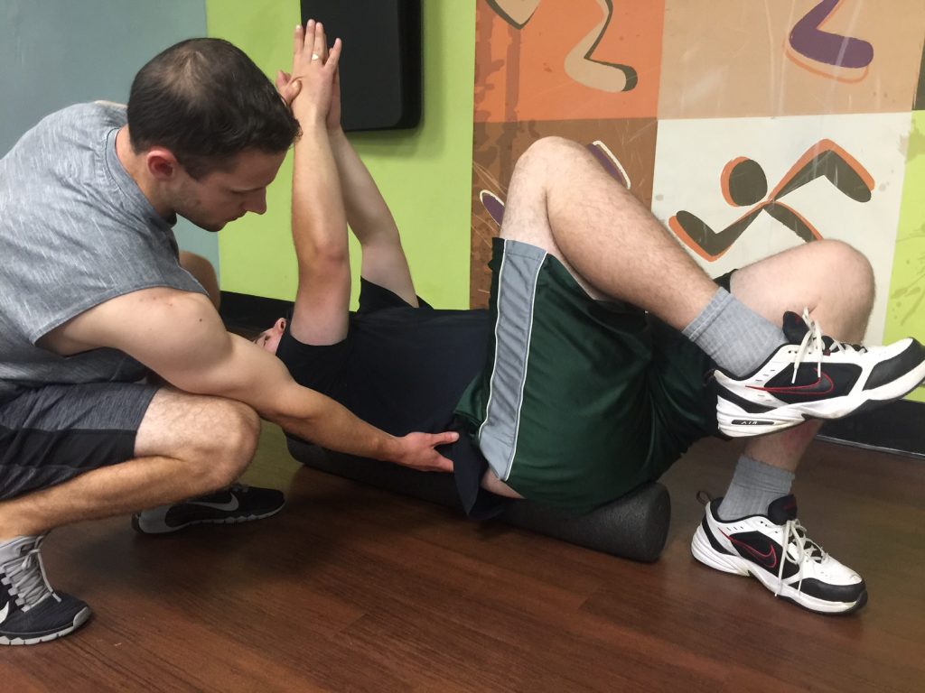 Scott Sessions of Sessions Be-Fit doing flexibility training with a client