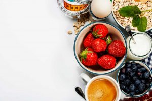 image of strawberries, blueberries, yogurt and coffee